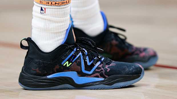 View of black and blue New Balance shoes.